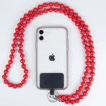 Iphone 11 Mit Transparenter Hülle Und Roter Perlenkette, Produktfotografie Auf Weißem Hintergrund.